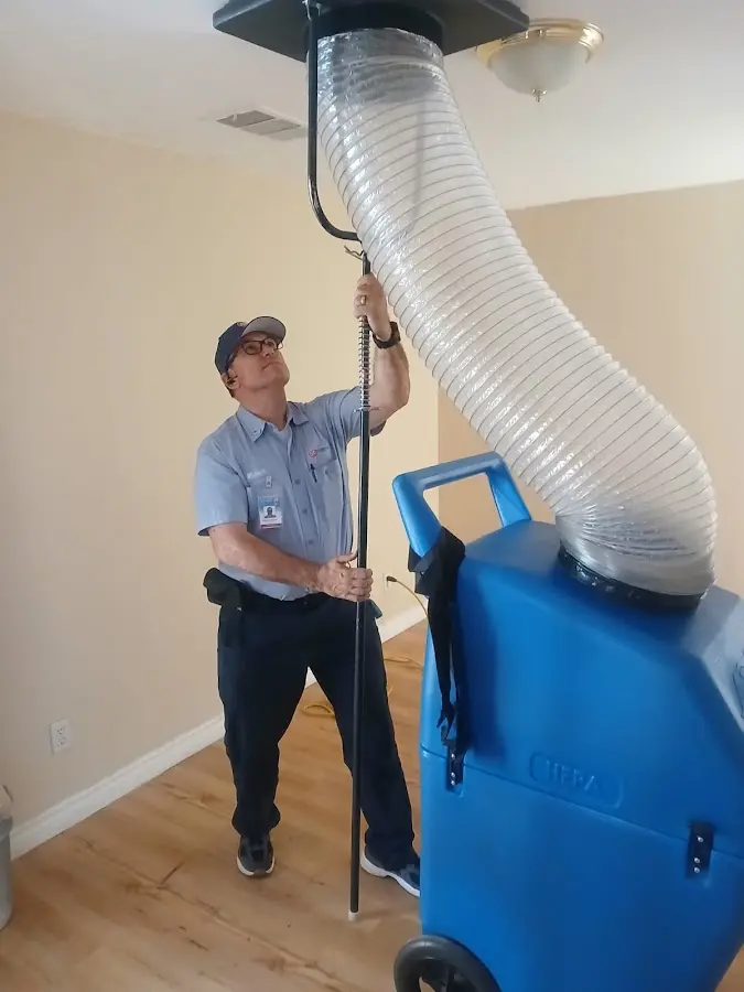 Furnace Tune-Up technician using HEPA equipment in Boulder Hill